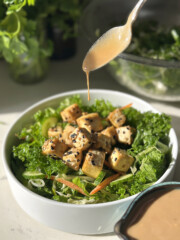 creamy sesame dressing drizzling over tofu salad